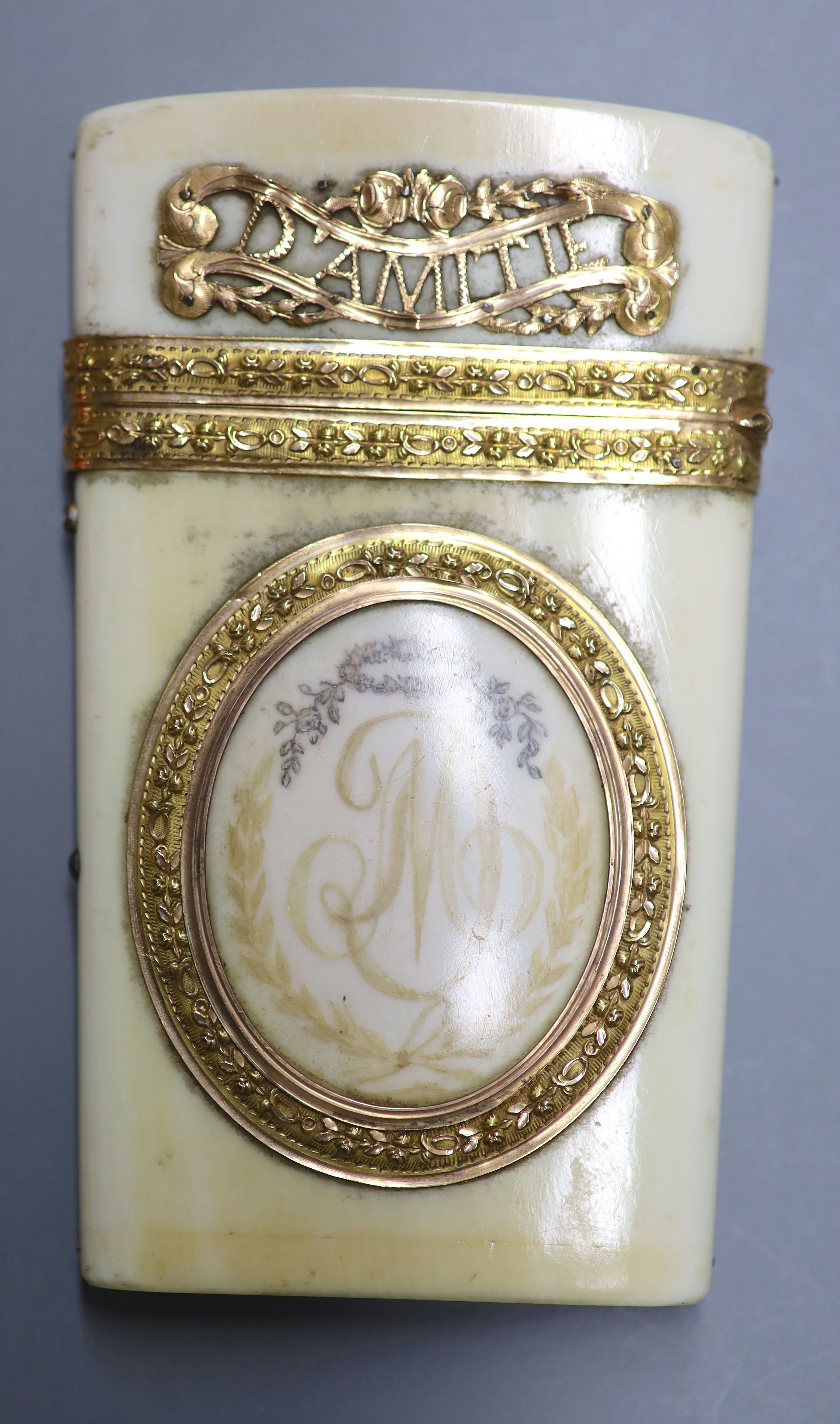 A 19th century French yellow metal mounted ivory etui, inscribed Amitie & Souvenir with two fold notelet inside, 9CM